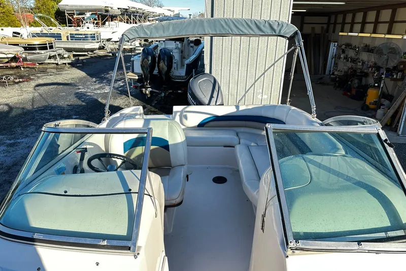 Slide: The Image of 2002 Godfrey Hurricane 237 boat with seating and canopy in a storage area. - 5