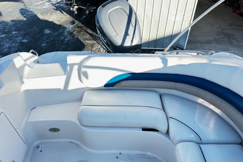 Slide: The Image of 2002 Godfrey Hurricane 237 boat interior with white seating and Yamaha outboard motor. - 9
