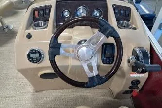 Slide: The Image of 2022 Bennington 21 SFXDI boat dashboard with steering wheel and control panel. - 4