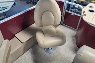 Slide: The Image of 2022 Bennington 21 SFXDI boat interior with beige seating and red paneling. - 5