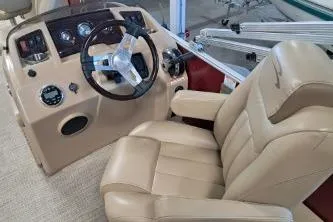 Slide: The Image of 2022 Bennington 21 SFXDI boat interior with steering wheel and beige captain's chair. - 6