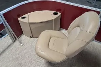 Slide: The Image of 2022 Bennington 21 SFXDI boat interior with beige seating and red paneling. - 9