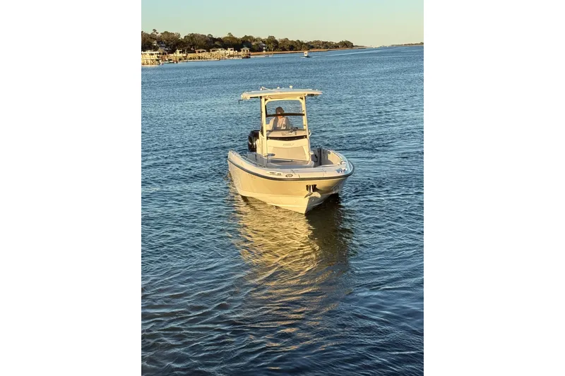Slide: The Image of 2016 Boston Whaler 270 Dauntless boat on calm water at sunset. - 12