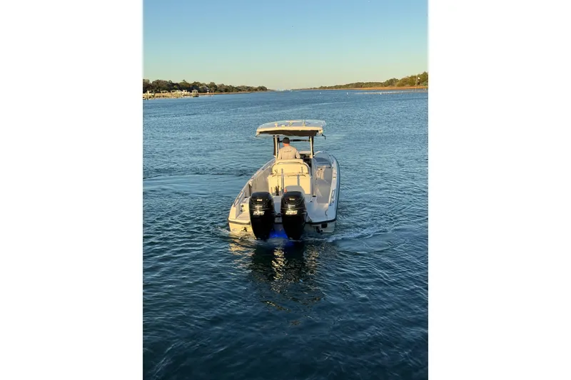 Slide: The Image of 2016 Boston Whaler 270 Dauntless boat cruising on a calm waterway. - 16
