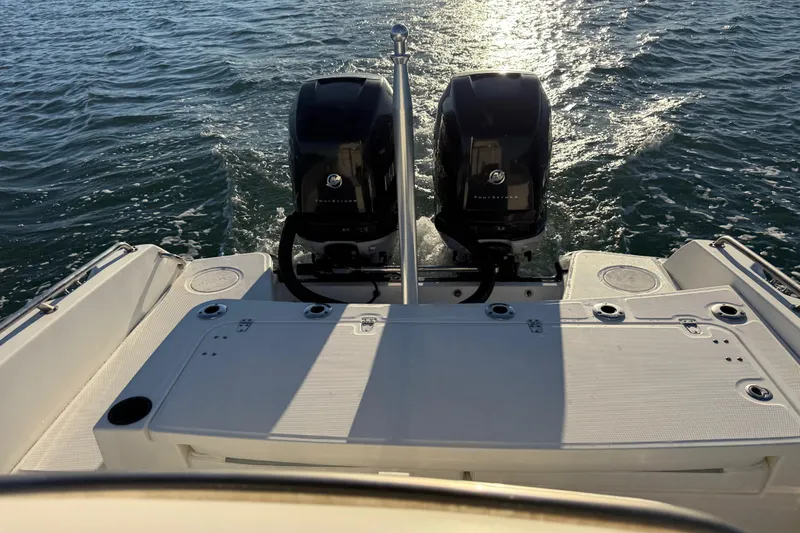 Slide: The Image of 2016 Boston Whaler 270 Dauntless with dual outboard engines on open water. - 23