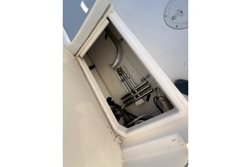 Slide: The Image of Storage compartment of a 2016 Boston Whaler 270 Dauntless boat, showing equipment and wiring. - 27