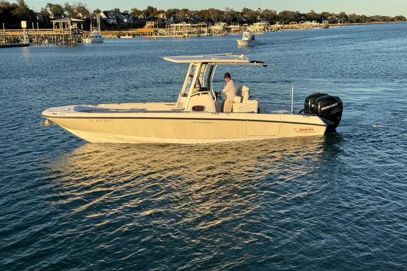 Slide: The Image of 2016 Boston Whaler 270 Dauntless boat on calm water, with a person onboard. - 3