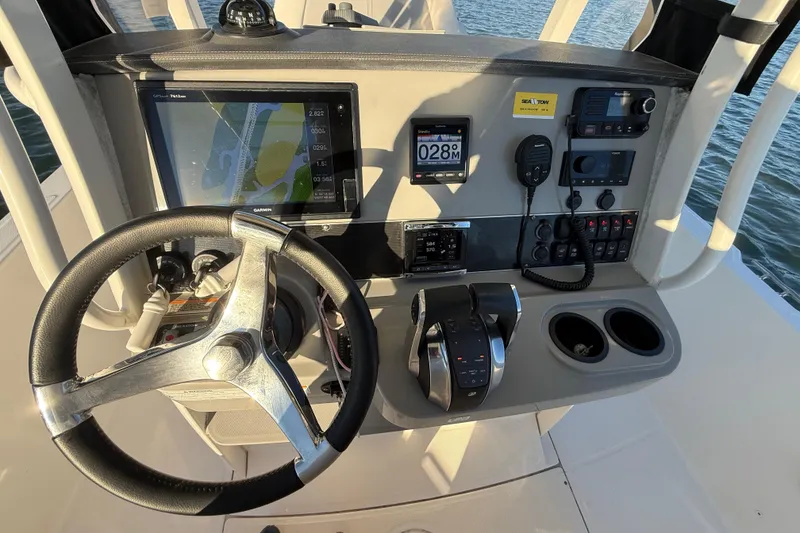 Slide: The Image of 2016 Boston Whaler 270 Dauntless helm with steering wheel, navigation, and control panel. - 30