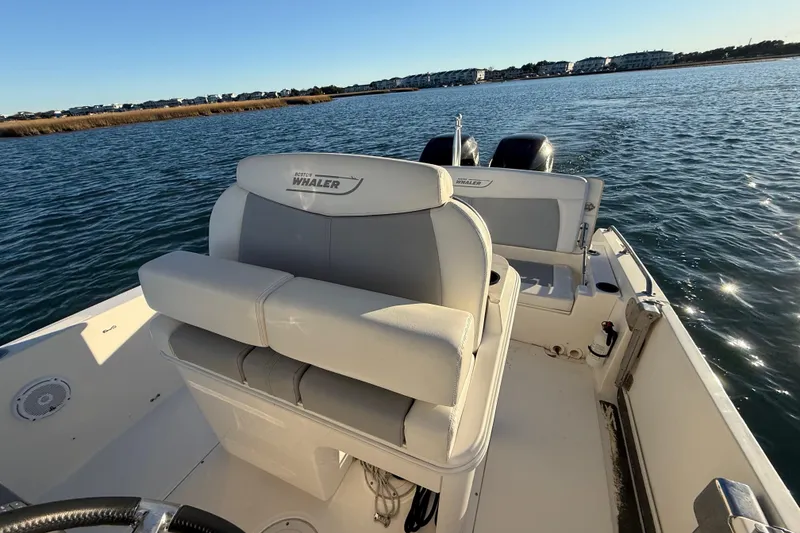 Slide: The Image of 2016 Boston Whaler 270 Dauntless boat on water, featuring comfortable seating and dual engines. - 31