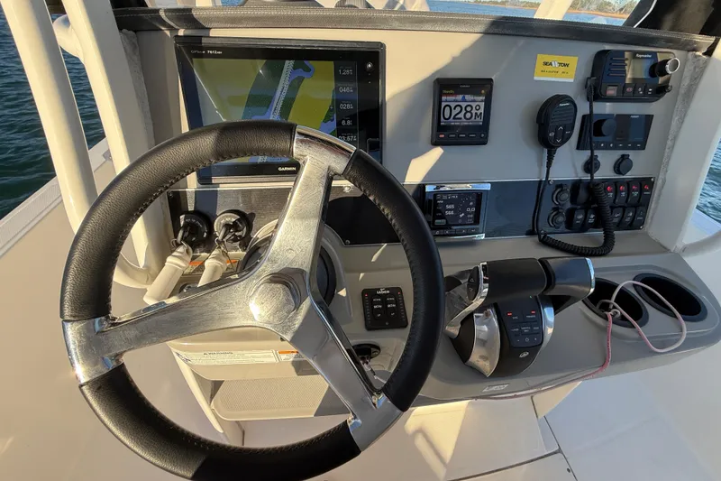Slide: The Image of Steering console of a 2016 Boston Whaler 270 Dauntless with navigation and control systems. - 32