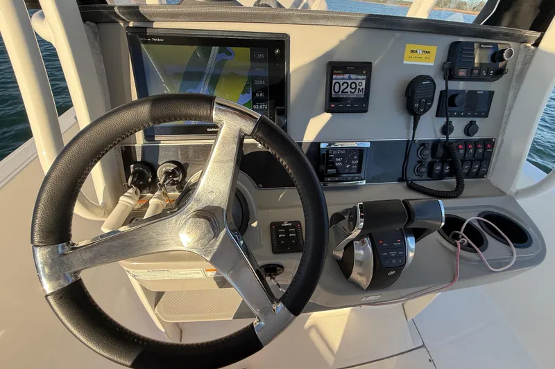 Slide: The Image of Steering console of 2016 Boston Whaler 270 Dauntless with navigation and control systems. - 33