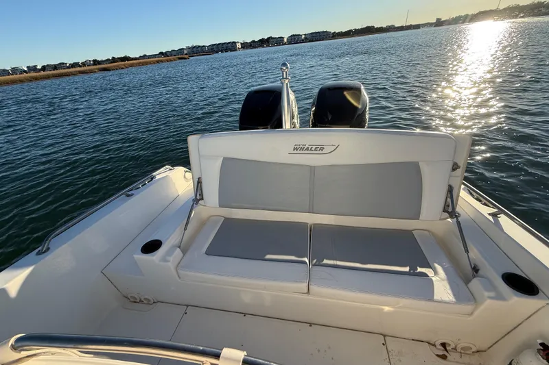 Slide: The Image of 2016 Boston Whaler 270 Dauntless boat on water, rear seating view, sunny day. - 35