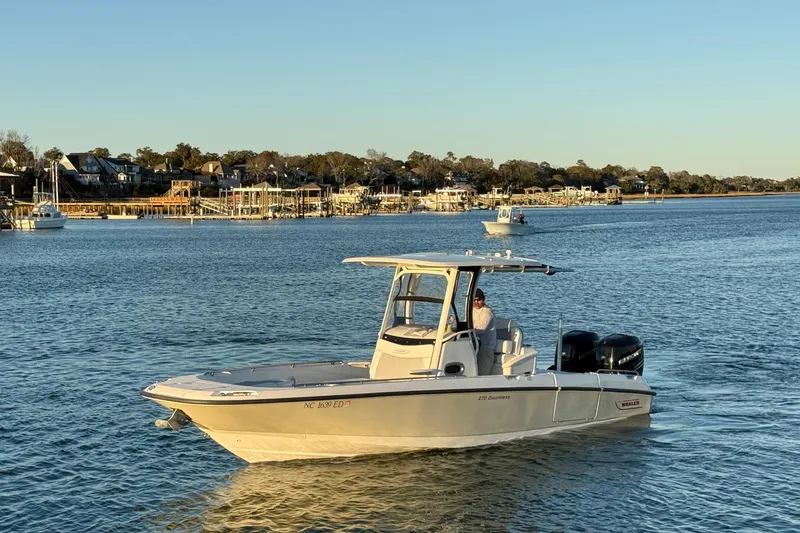 Slide: The Image of 2016 Boston Whaler 270 Dauntless boat cruising on a calm waterway. - 4