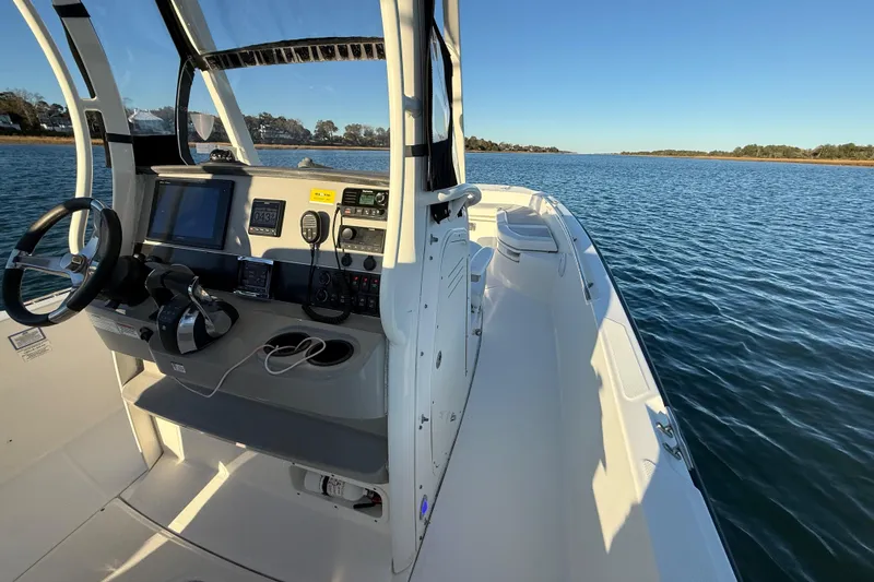 Slide: The Image of 2016 Boston Whaler 270 Dauntless boat on calm water, featuring a modern helm. - 41