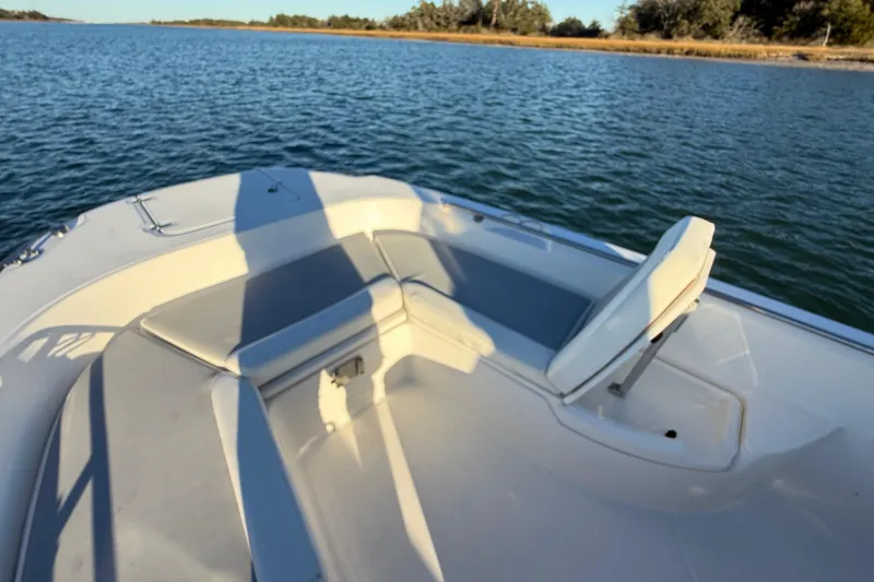 Slide: The Image of 2016 Boston Whaler 270 Dauntless boat interior with seating, on calm water. - 47