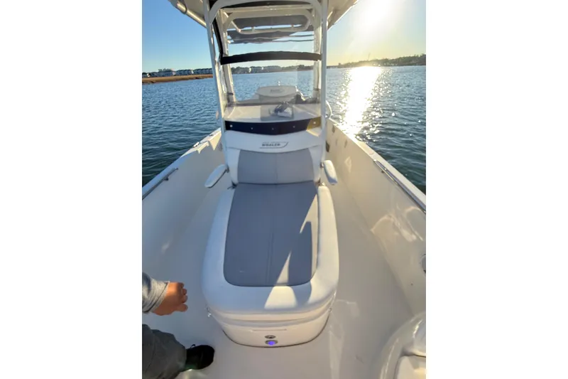 Slide: The Image of 2016 Boston Whaler 270 Dauntless boat on water, sunny day, sleek design. - 49