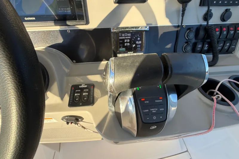 Slide: The Image of Control panel of a 2016 Boston Whaler 270 Dauntless boat with throttle and navigation equipment. - 53