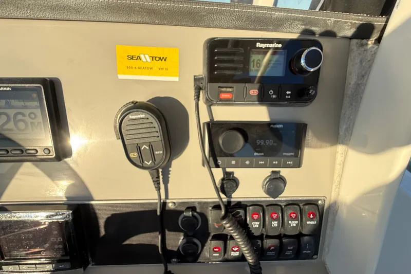 Slide: The Image of Control panel of a 2016 Boston Whaler 270 Dauntless with navigation and communication equipment. - 54