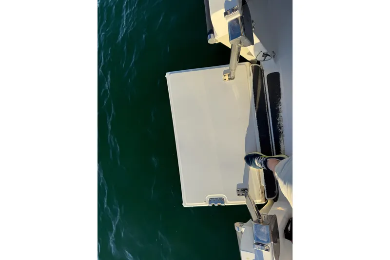 Slide: The Image of 2016 Boston Whaler 270 Dauntless boat deck with foot, overlooking water. - 56