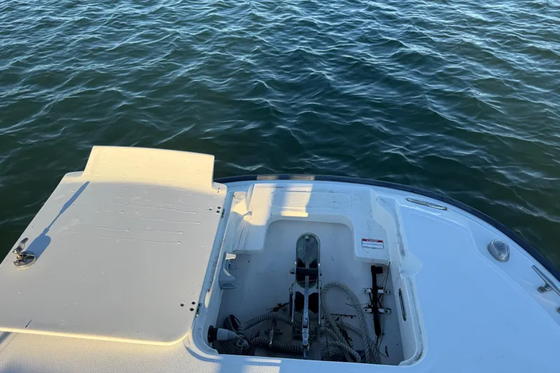 Slide: The Image of 2016 Boston Whaler 270 Dauntless boat deck with open storage compartment on water. - 59