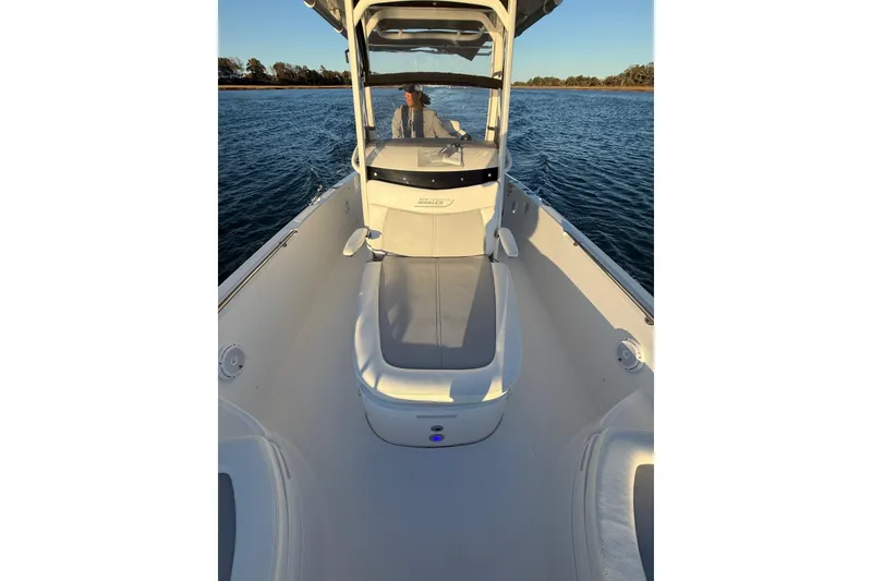 Slide: The Image of 2016 Boston Whaler 270 Dauntless boat on water, featuring spacious deck and seating. - 63