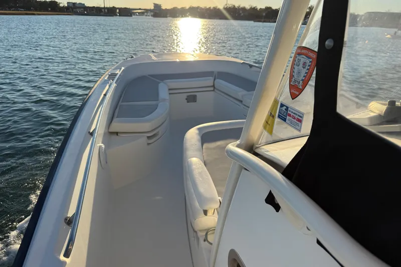 Slide: The Image of 2016 Boston Whaler 270 Dauntless boat on water at sunset, interior view. - 64