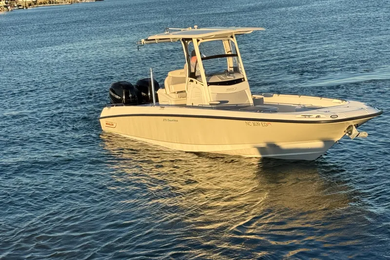 Slide: The Image of 2016 Boston Whaler 270 Dauntless boat on calm water, featuring twin engines. - 8