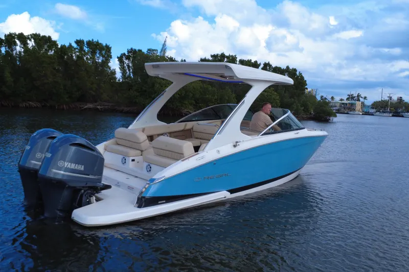 Slide: The Image of 2018 Regal 29 OBX boat with Yamaha engines cruising on a scenic waterway. - 10