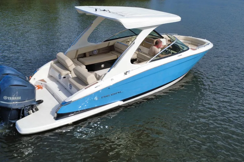 Slide: The Image of 2018 Regal 29 OBX boat with Yamaha engines on a calm lake. - 11