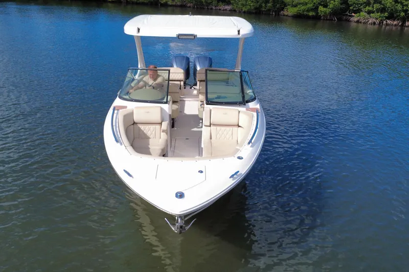 Slide: The Image of 2018 Regal 29 OBX boat cruising on calm water, featuring spacious seating and sleek design. - 16