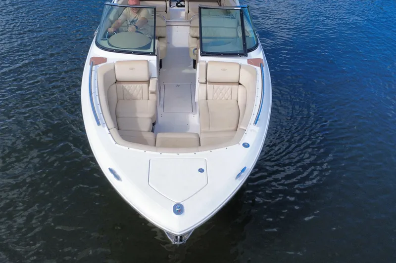 Slide: The Image of 2018 Regal 29 OBX boat with beige seating on calm water. - 17