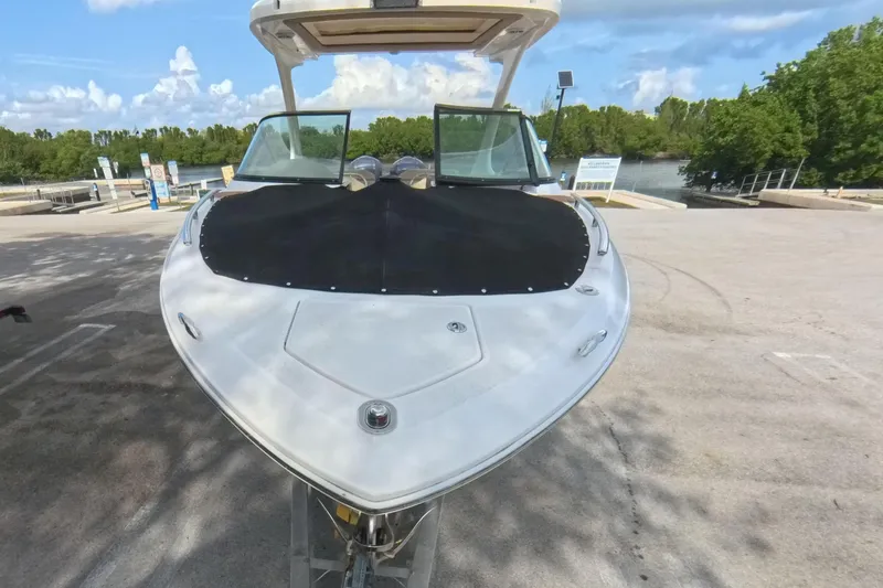 Slide: The Image of 2018 Regal 29 OBX boat on trailer at a sunny marina. - 18