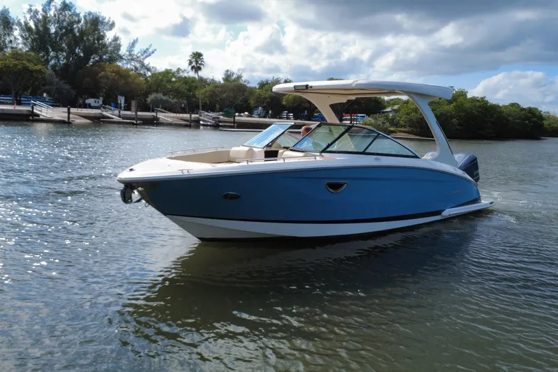 Slide: The Image of 2018 Regal 29 OBX boat cruising on a sunny day in a scenic waterway. - 2