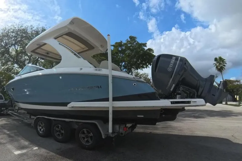 Slide: The Image of 2018 Regal 29 OBX boat on trailer in sunny parking lot. - 23