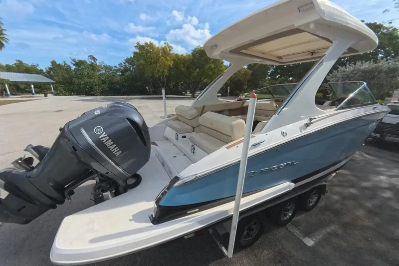 Slide: The Image of 2018 Regal 29 OBX boat with Yamaha outboard motor, parked on a trailer. - 27
