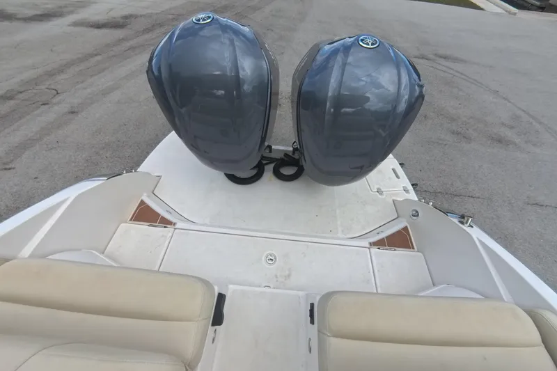 Slide: The Image of 2018 Regal 29 OBX boat with dual outboard motors, beige seating, and spacious deck. - 33