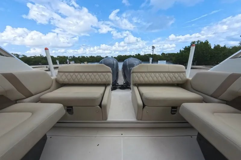 Slide: The Image of 2018 Regal 29 OBX boat interior with beige seating and twin outboard motors. - 34