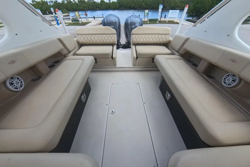 Slide: The Image of 2018 Regal 29 OBX boat interior with beige seating and twin outboard motors. - 39