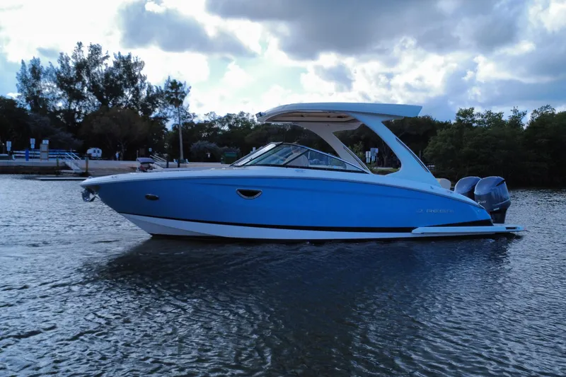 Slide: The Image of 2018 Regal 29 OBX boat on calm water under cloudy sky. - 4