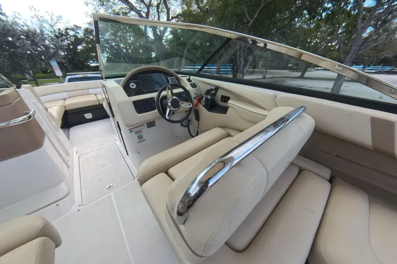 Slide: The Image of Interior view of 2018 Regal 29 OBX boat with beige seating and steering console. - 41