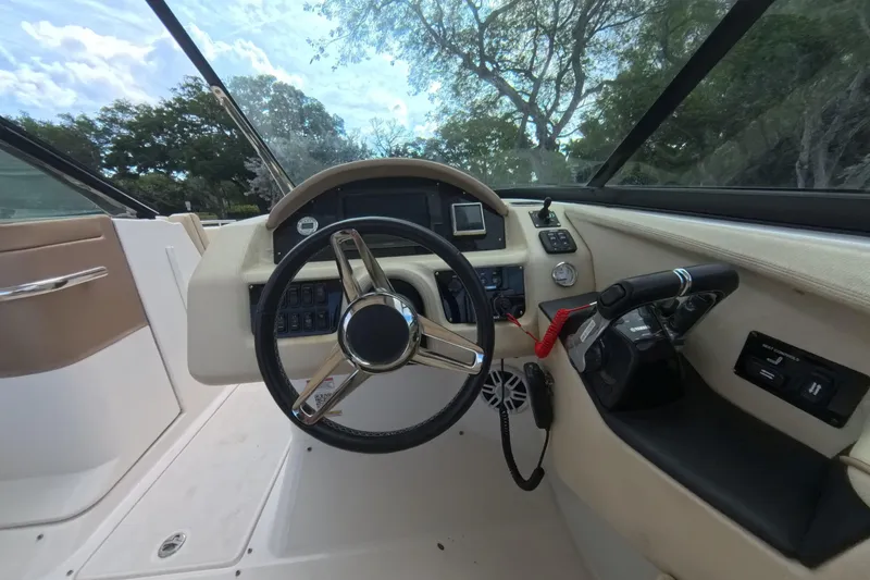 Slide: The Image of 2018 Regal 29 OBX boat helm with steering wheel and control panel. - 43