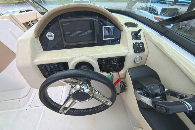 Slide: The Image of 2018 Regal 29 OBX boat dashboard with steering wheel and control panel. - 44