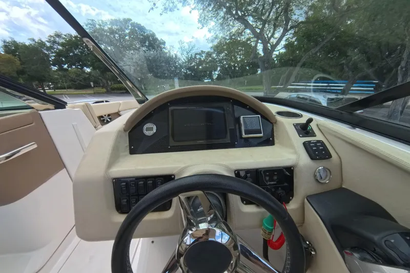 Slide: The Image of 2018 Regal 29 OBX boat dashboard with steering wheel and control panel. - 45