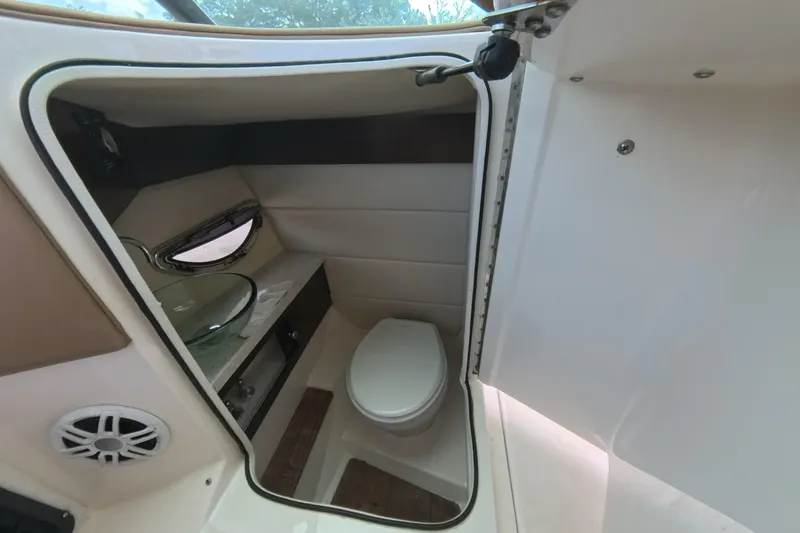 Slide: The Image of 2018 Regal 29 OBX boat interior bathroom with toilet and sink. - 48