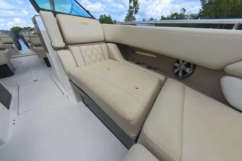 Slide: The Image of Luxurious seating on 2018 Regal 29 OBX boat with beige upholstery and cup holders. - 51