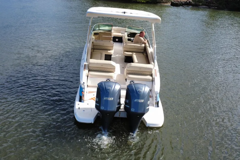 Slide: The Image of 2018 Regal 29 OBX boat with dual Yamaha 250 engines on calm water. - 8