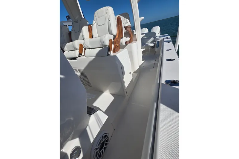 Slide: The Image of 2024 SeaVee 420Z boat interior with white seating and ocean backdrop. - 14