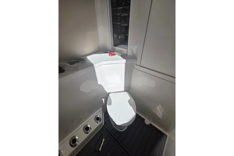 Slide: The Image of 2024 SeaVee 420Z boat interior bathroom with modern toilet and control panel. - 15