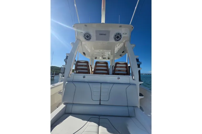 Slide: The Image of 2024 SeaVee 420Z boat interior with seating and electronics under clear blue sky. - 5