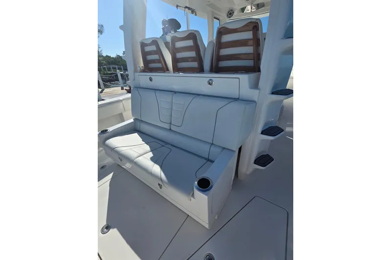 Slide: The Image of 2024 SeaVee 420Z boat seating area with cushioned seats and cup holders. - 7